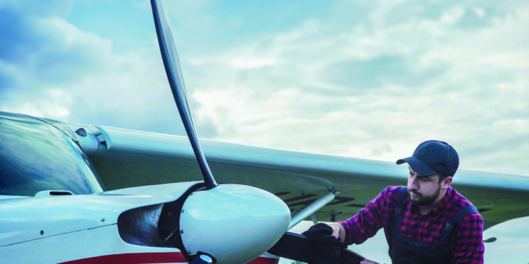 Aircraft mechanic polishing plane